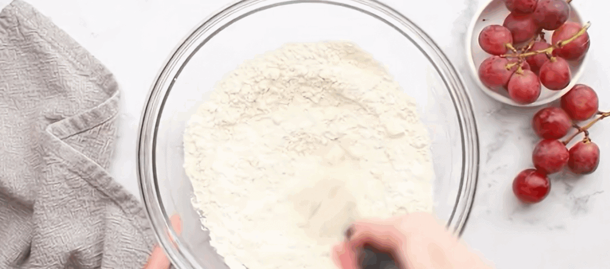 Combining the ingredients to make the crust for the grape pie.