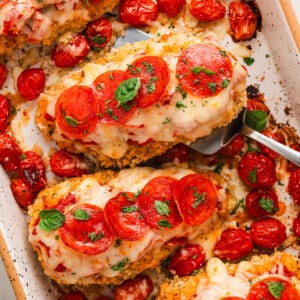 A spatula serving a piece of parmesan chicken