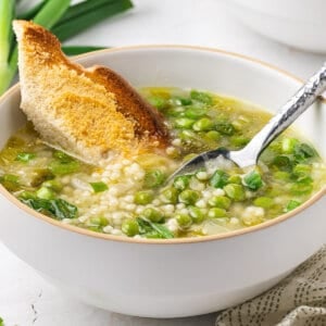 bowl of pea soup with dunked bread