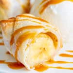 banana lumpia cut in half drizzled with caramel sauce