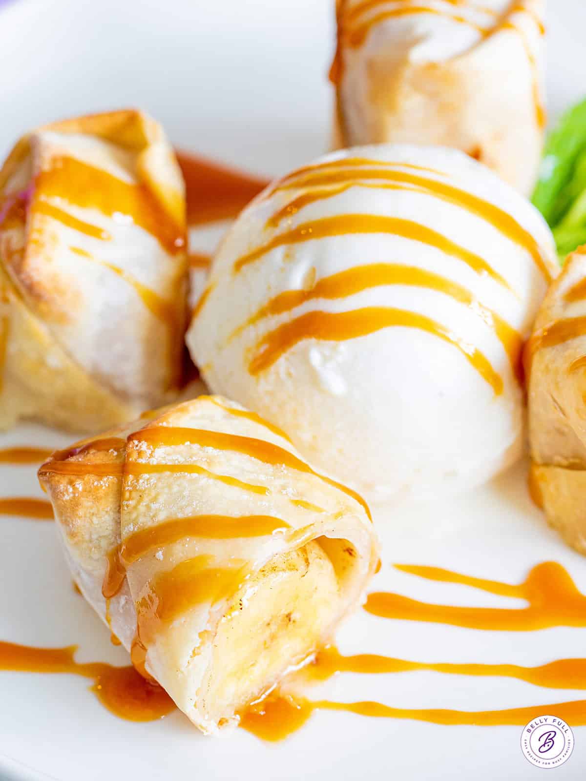 air fryer banana lumpia cut in half drizzled with caramel sauce