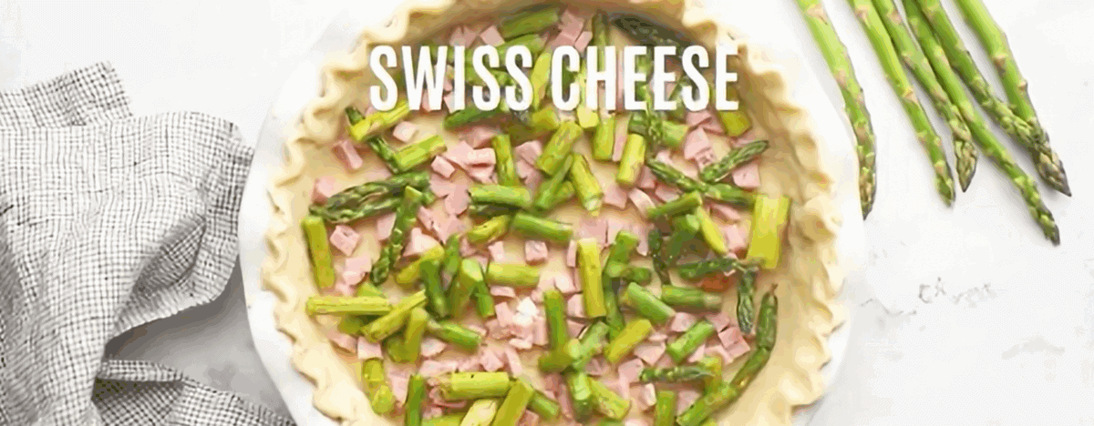 Placing the fillings in the pie crust: ham, asparagus, and cheese.