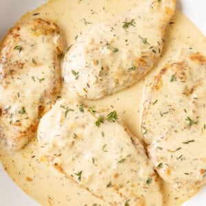 4 chicken breasts in pan with creamy dijon sauce