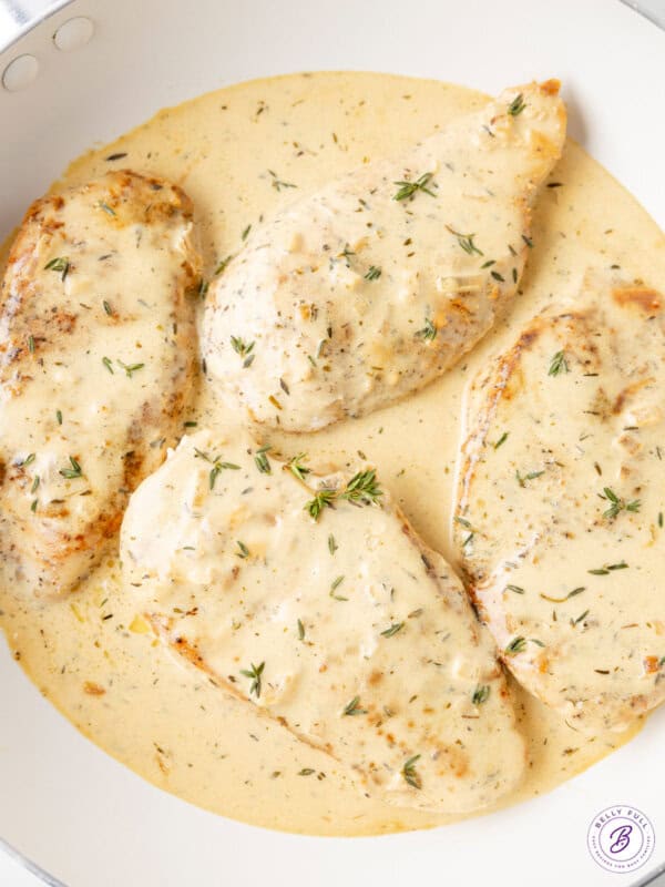 4 chicken breasts in pan with creamy dijon sauce