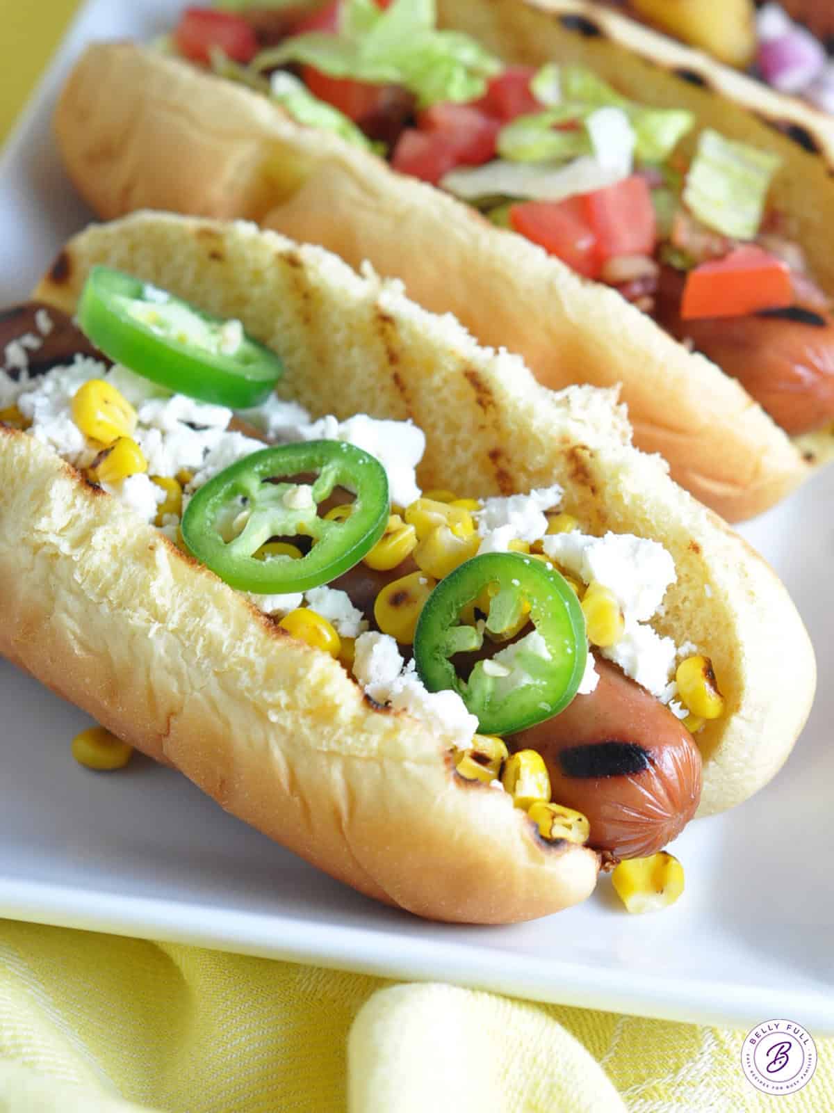 Grilled hot dog with feta cheese, corn, and jalapeno