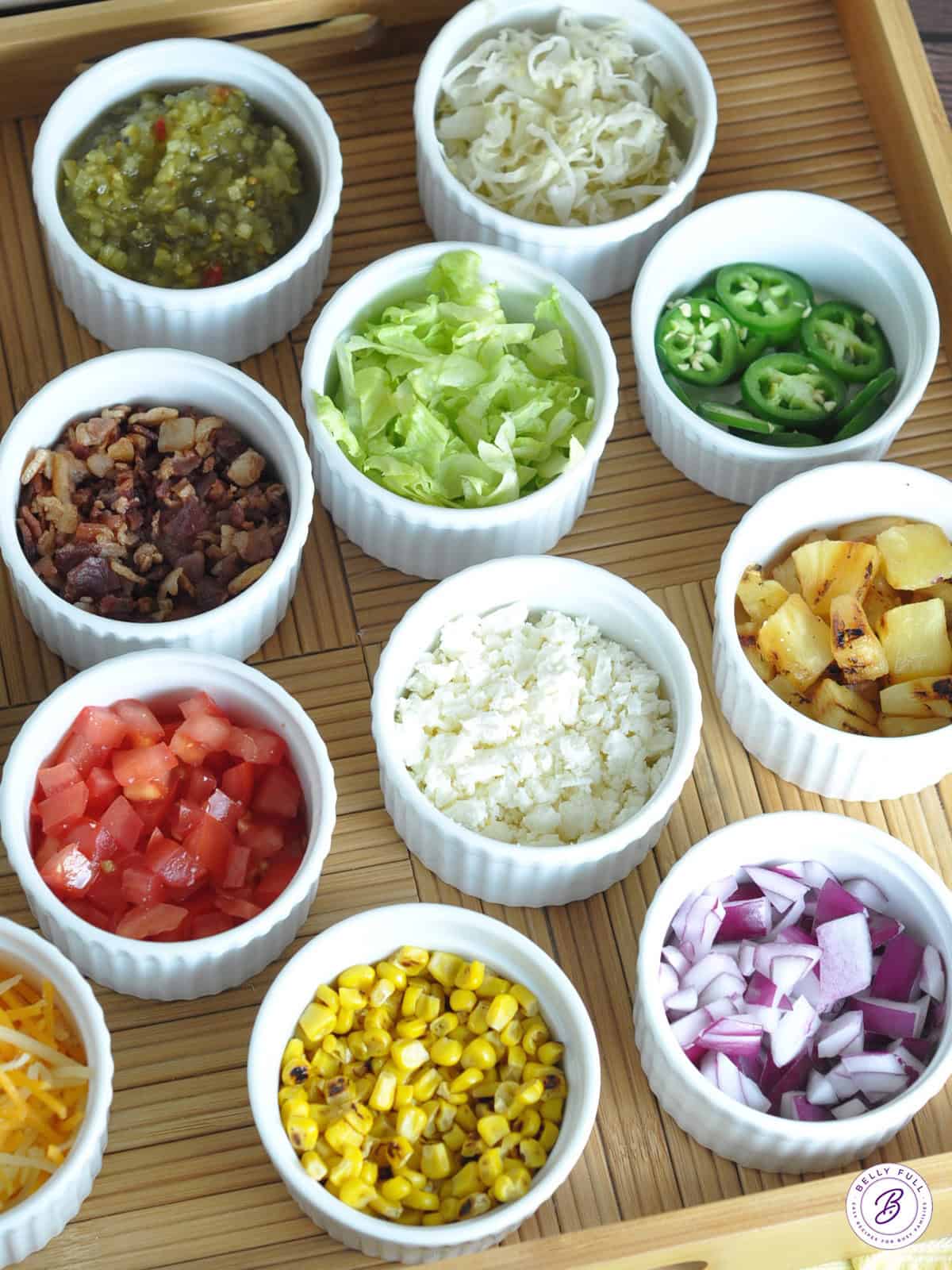 bowls of different toppings for grilled hot dogs