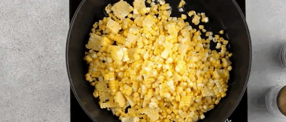 Cooking the corn in a skillet.