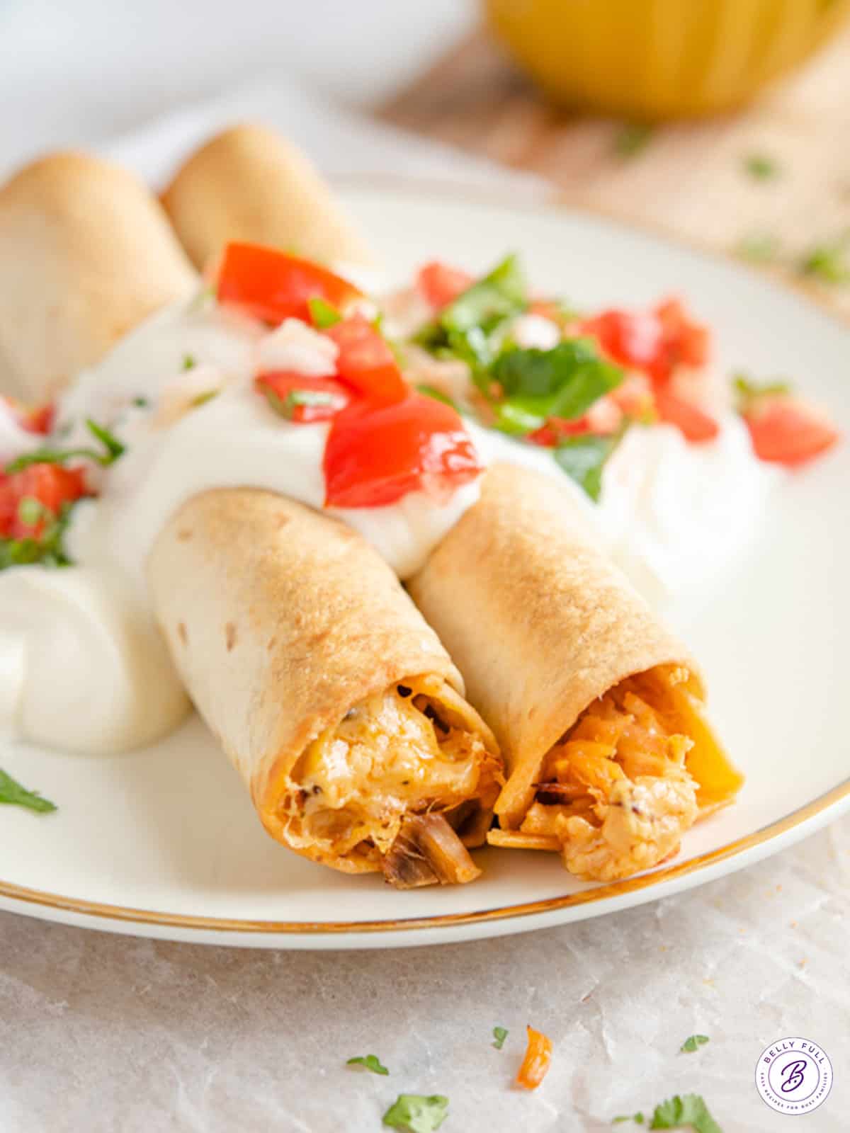 2 baked pork taquitos on plate