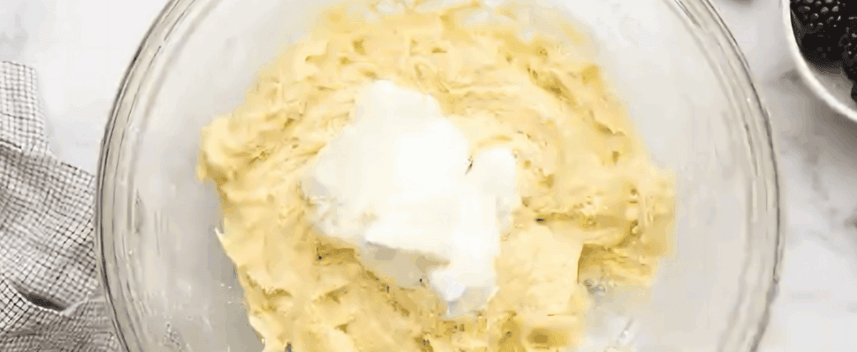 Adding sour cream to the batter.