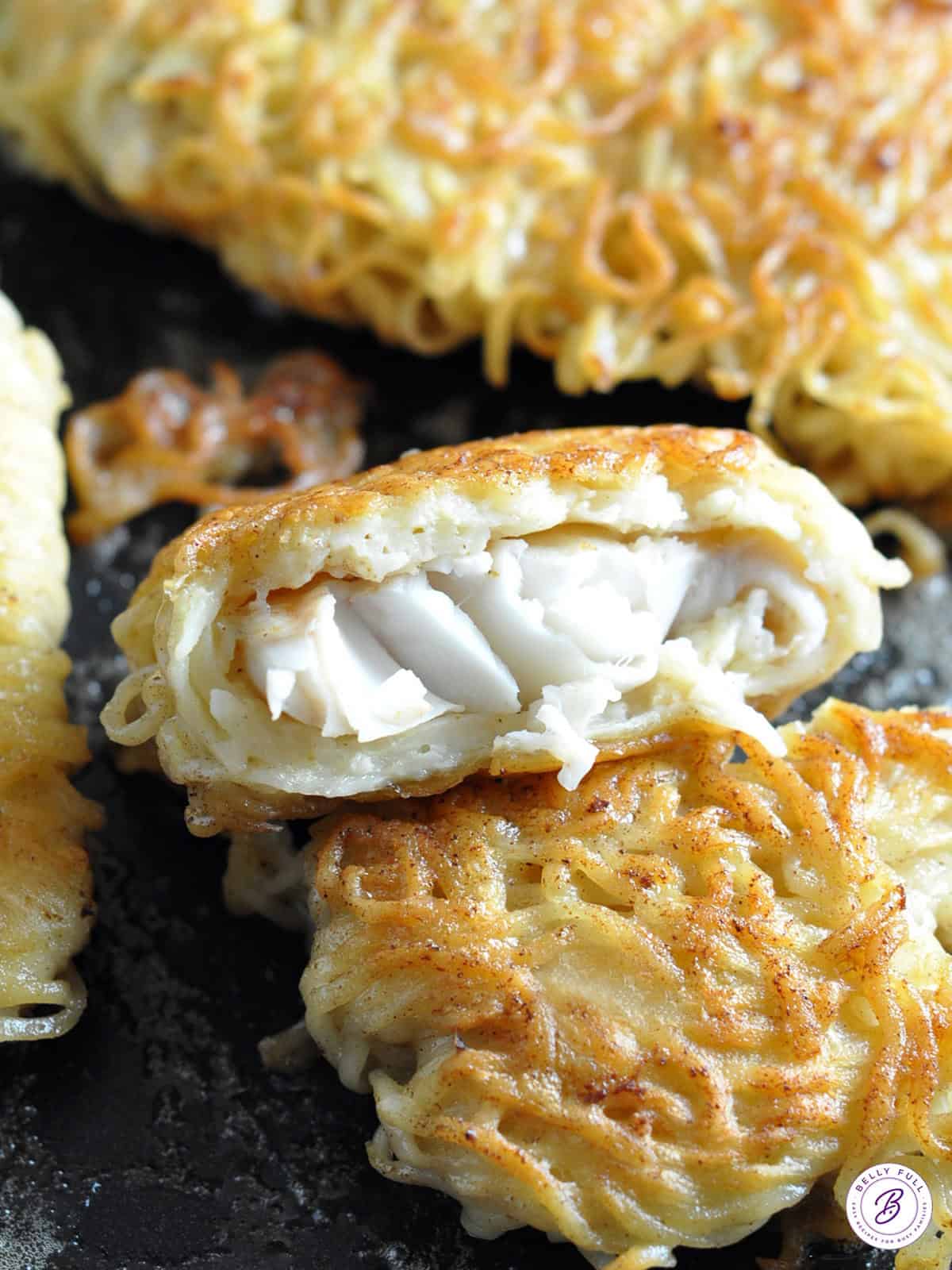 pan fried flaky cod wrapped in ramen noodles with bite taken