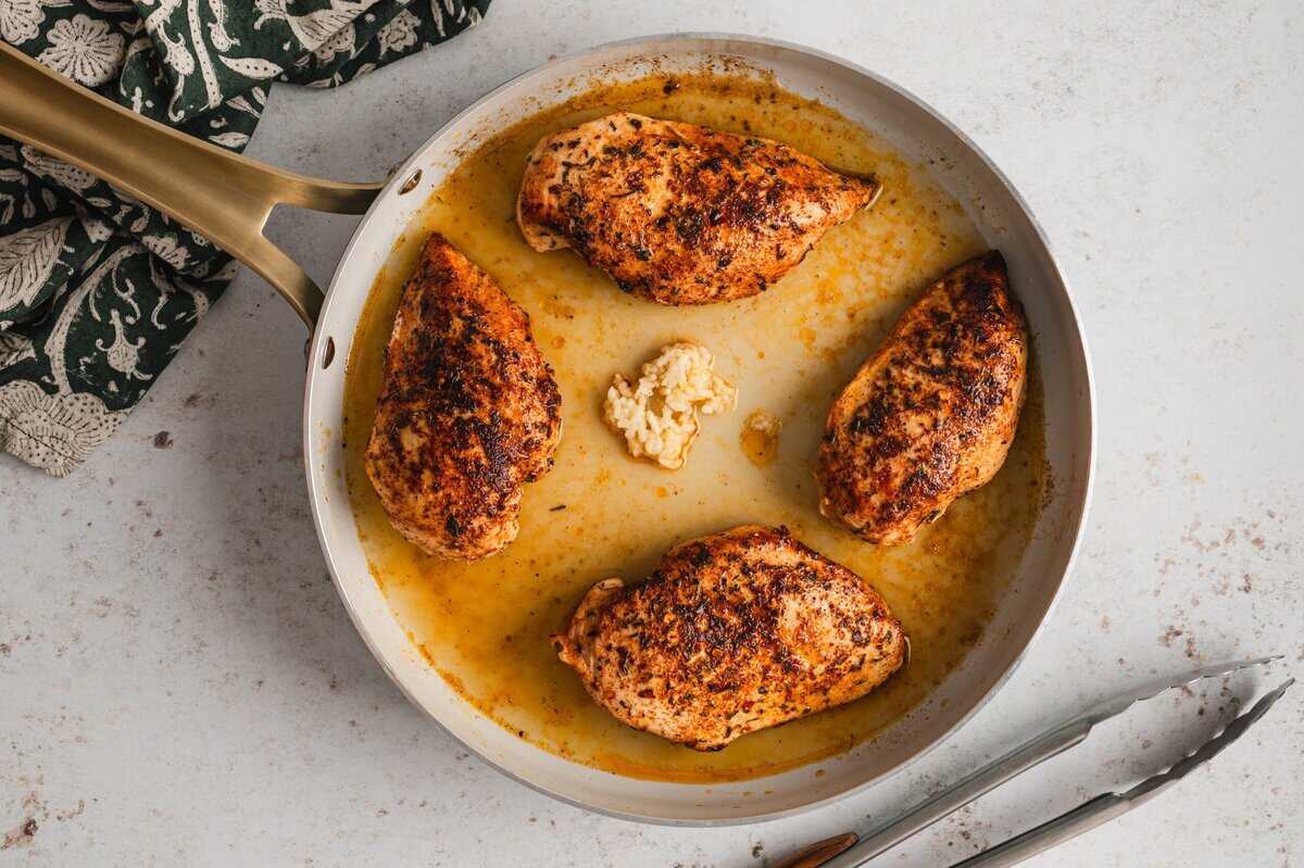 Garlic and lime juice added to the skillet with the chicken.