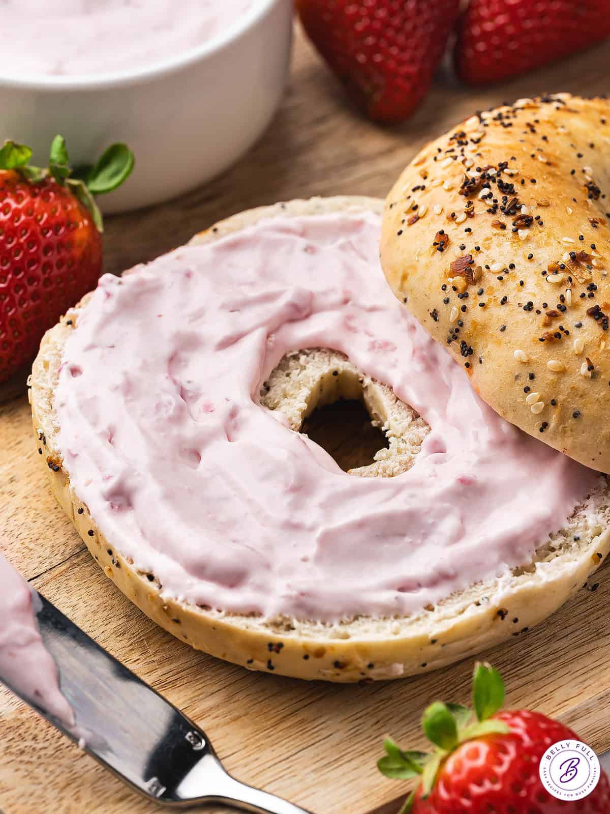 Strawberry cream cheese on a bagel