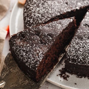 A slice of eggless chocolate cake being served