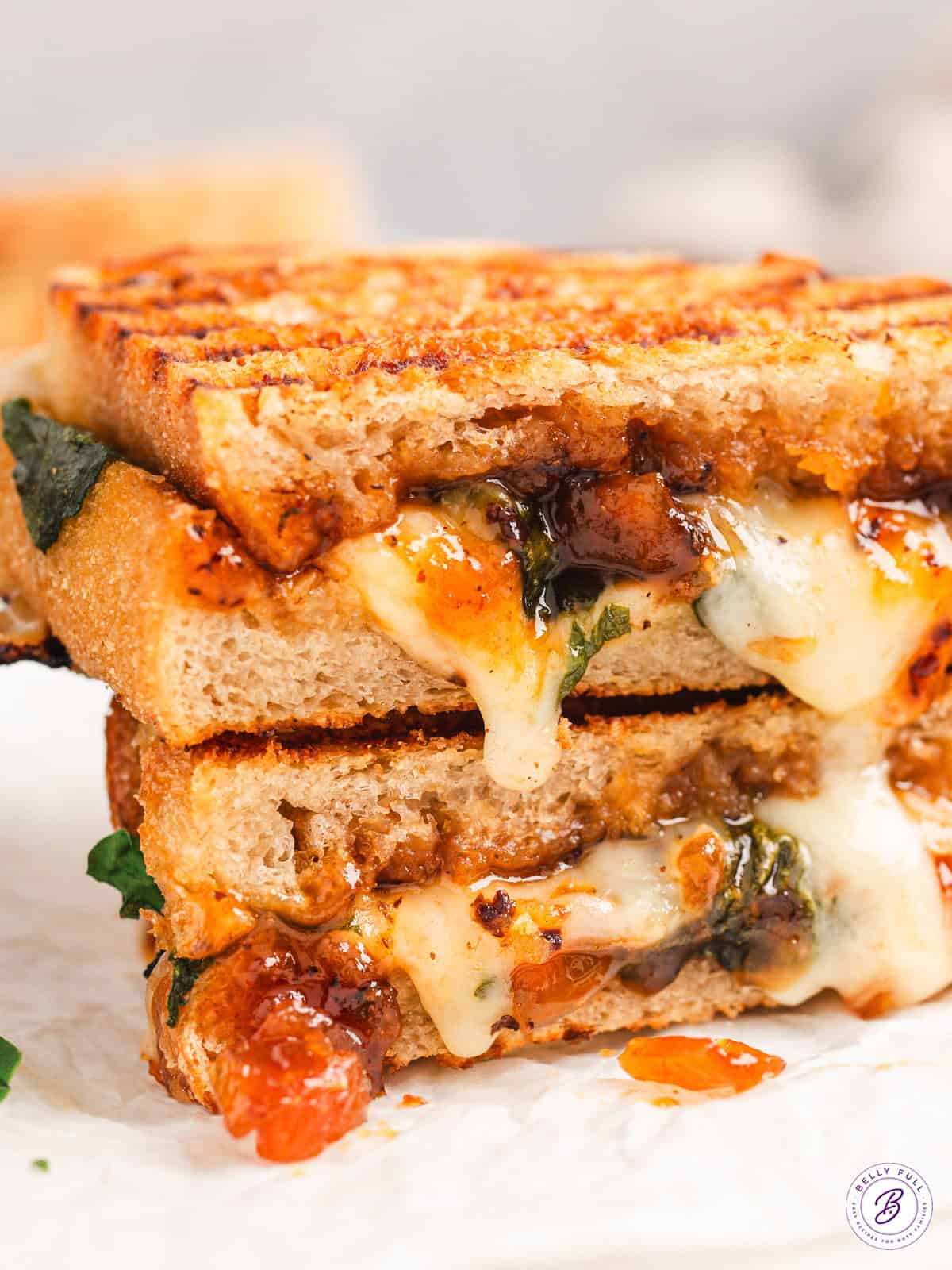 Bacon Jam Panini Cut in half with ooey gooey cheese