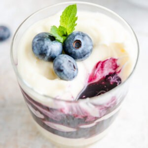 blueberry cheesecake parfaits topped with fresh blueberries