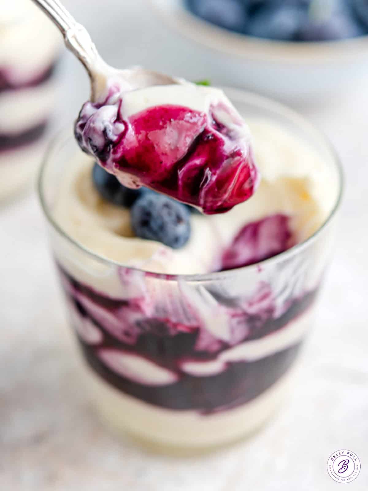 spoonful of cheesecake filling with blueberry sauce