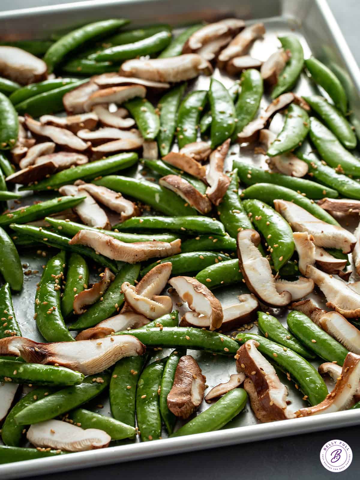 snap peas and shiitake mushrooms on roasting pan