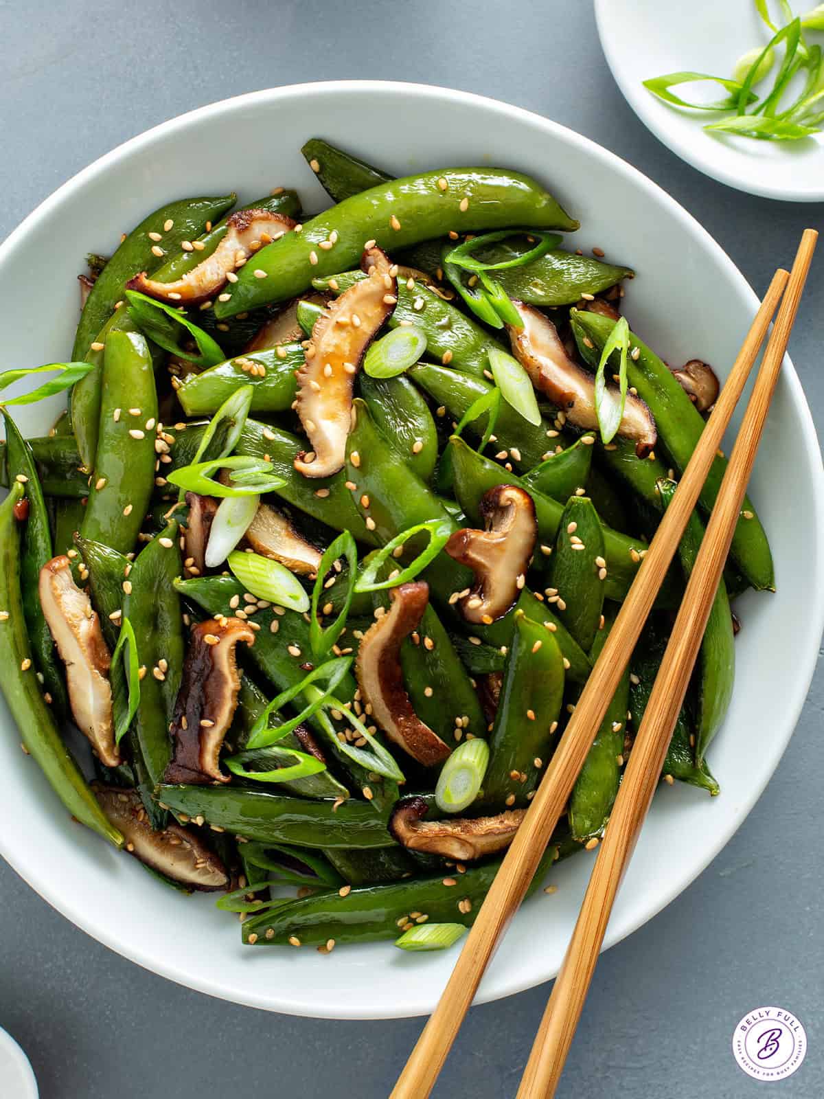 Roasted Snap Peas and mushrooms in bowl with chopsticks