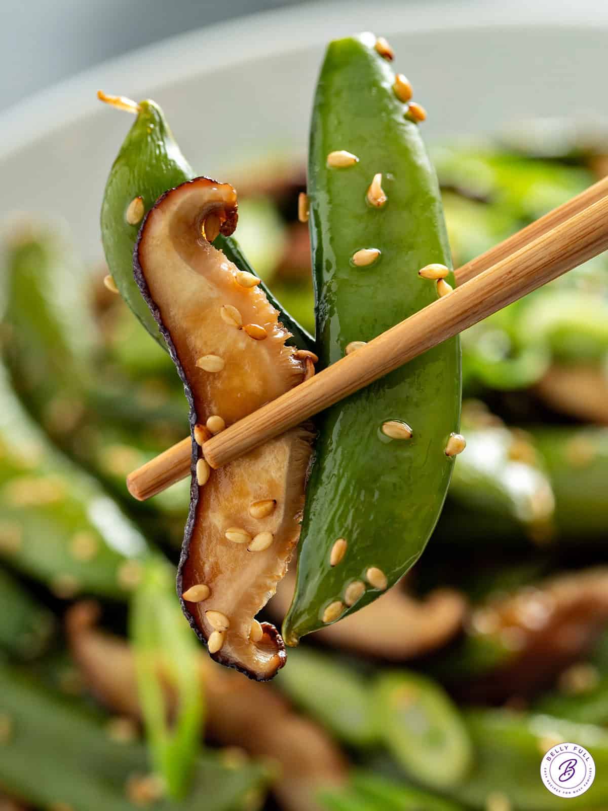 roasted snap pea and mushroom between chop sticks