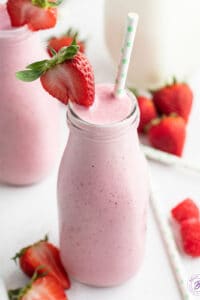 Creamy Strawberry Smoothie in tall glass with straw