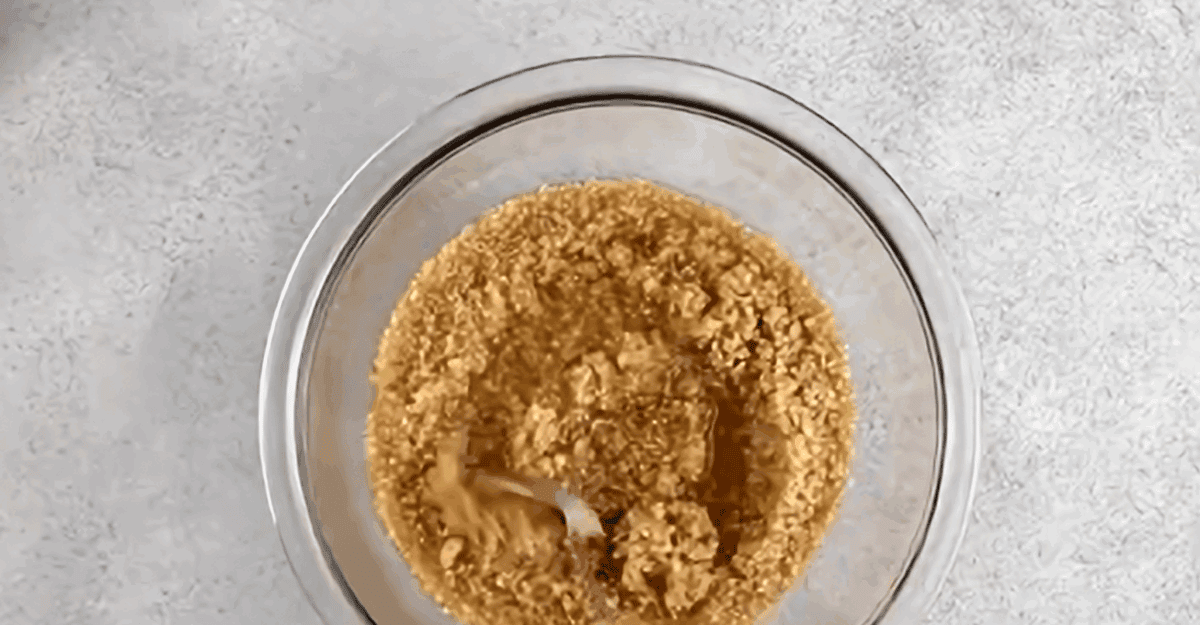 Bulghur soaking in water in a glass bowl.