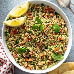overhead bowl of Tabbouleh with lemon wedges