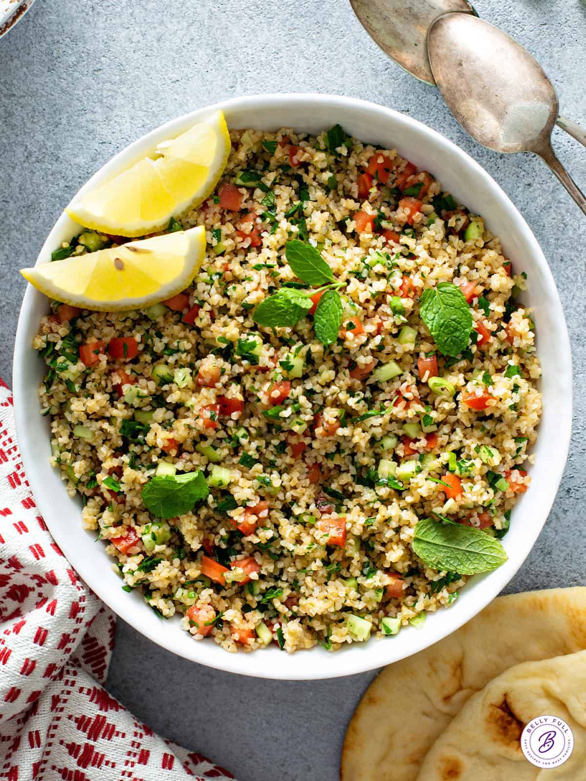 overhead bowl of Tabbouleh with lemon wedges