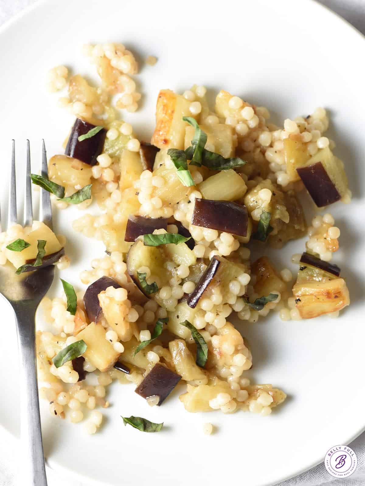 overhead pearl couscous side dish with eggplant and basil