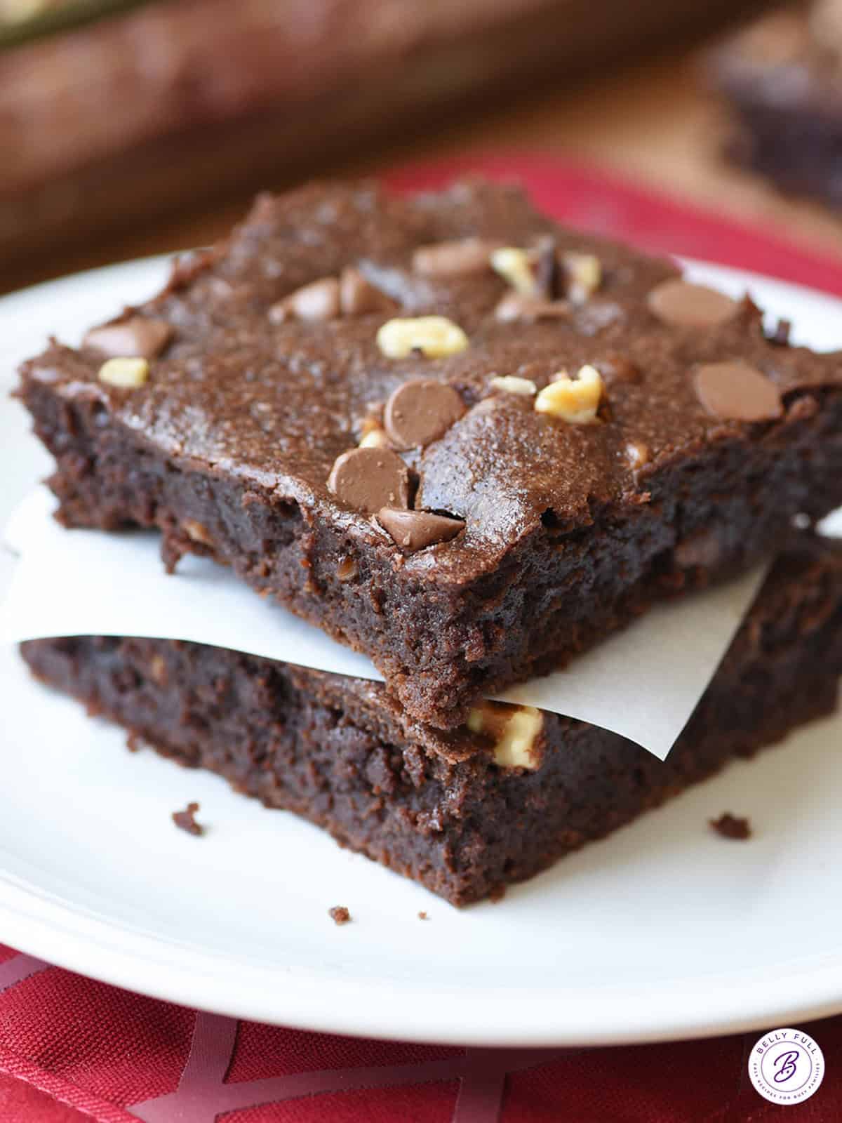 2 stacked fudgy brownies on plate