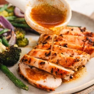 Soy butter sauce being poured over chicken