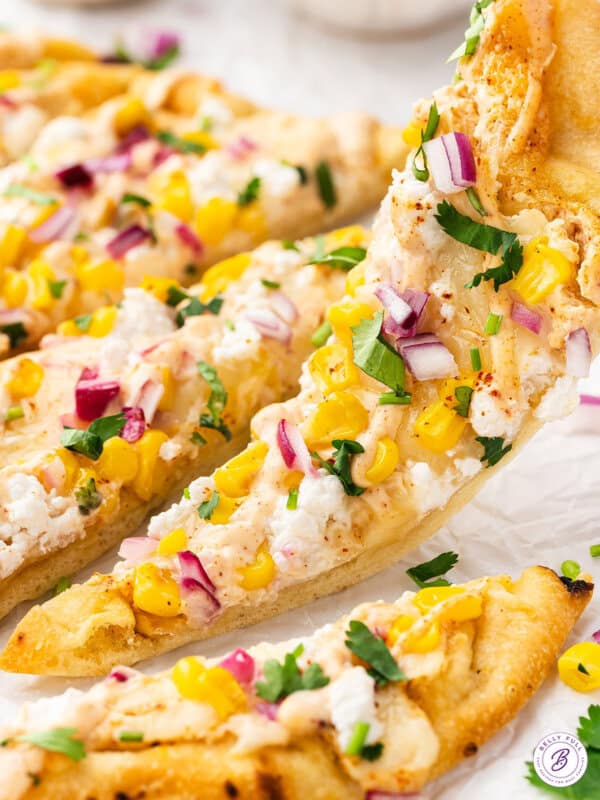 Picking up a slice of Mexican street corn flatbread