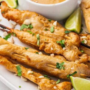 Chicken satay skewers on a plate