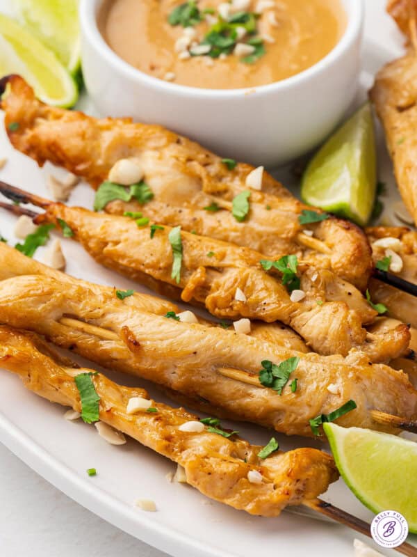 Chicken satay skewers on a plate