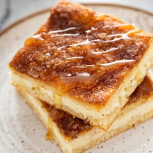 cheesecake bars with cinnamon-sugar crust and drizzled honey