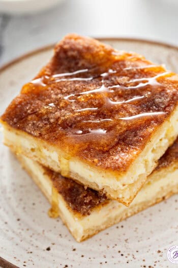 cheesecake bars with cinnamon-sugar crust and drizzled honey