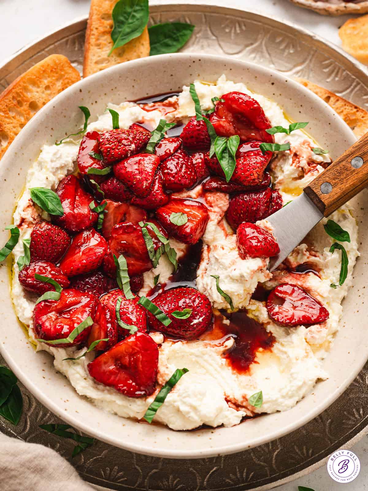 This Creamy Whipped Feta Dip recipe is made with just a few ingredients blended until smooth, light, and creamy. A bowl of whipped feta with balsamic strawberries