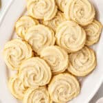 Overhead view of a butter cookies on a oval shaped serving dish.