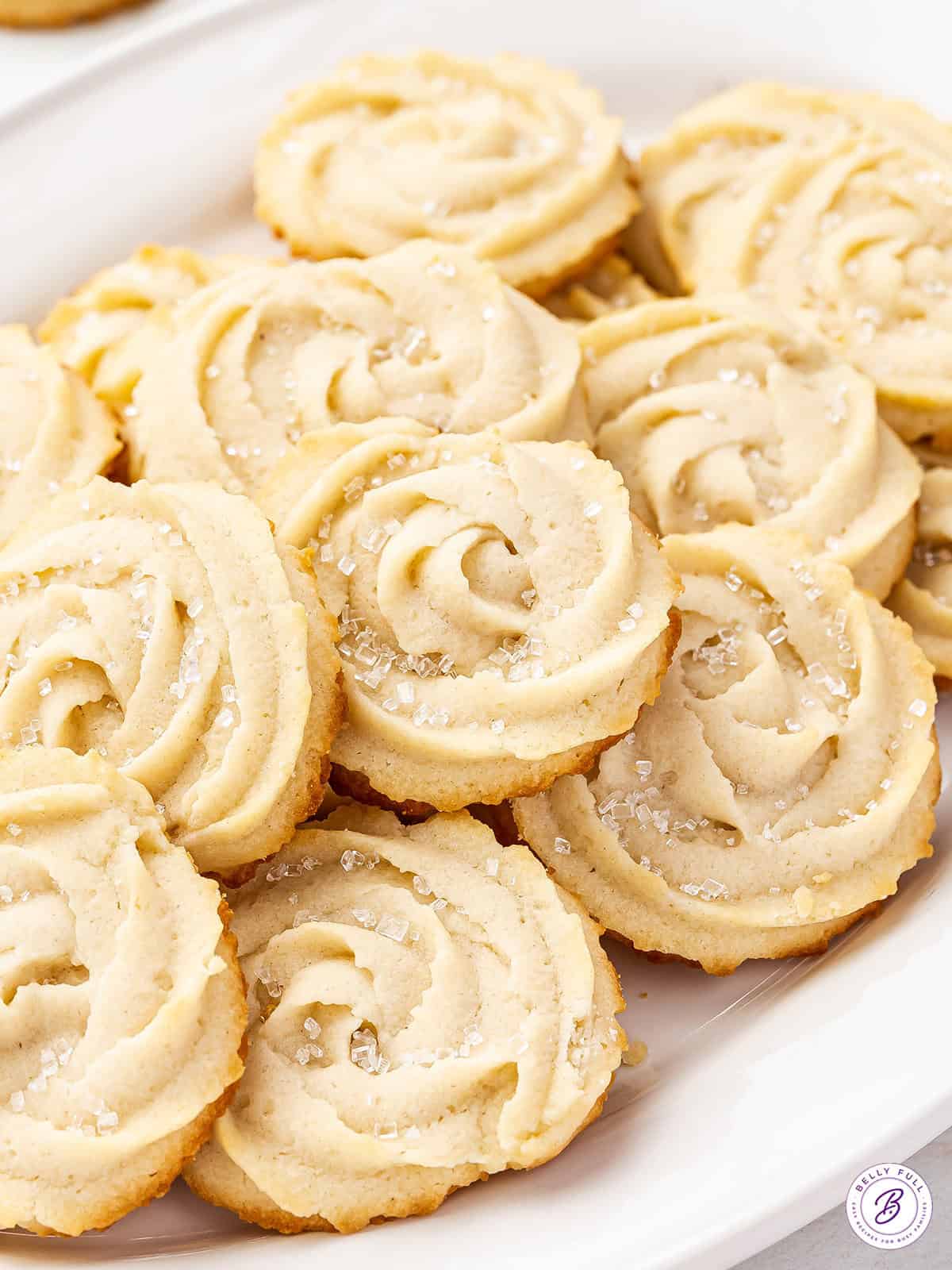 Close up of butter cookies on a oval shaped serving dish.