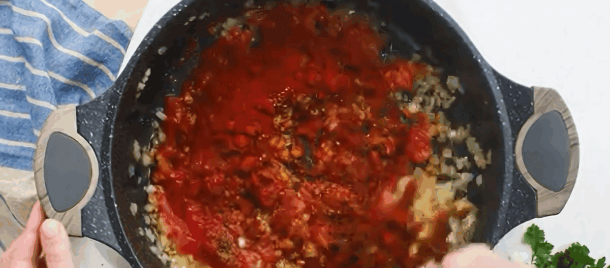 Cooking the ingredients to make the sauce for the chicken paprikash.