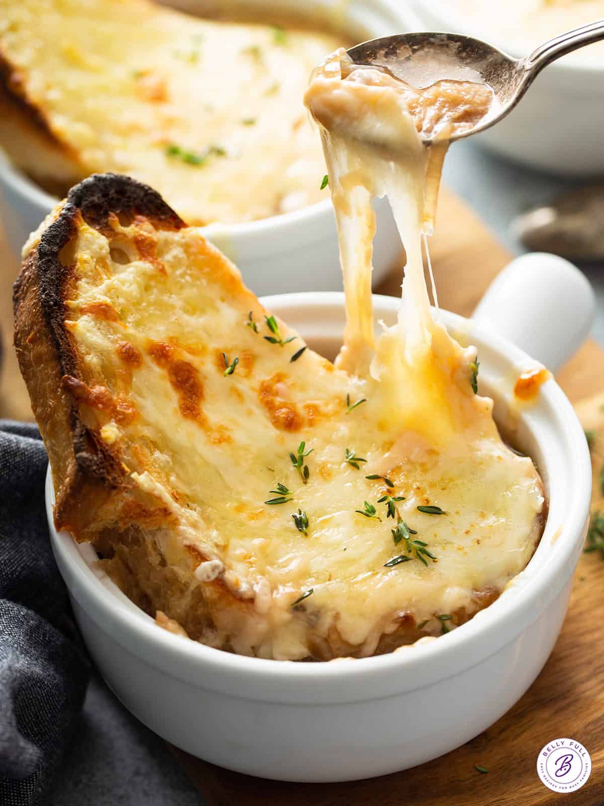 spoonful of soup with cheesy bread pull