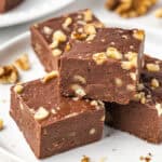 A close up of a stack of fudge on a white plate.