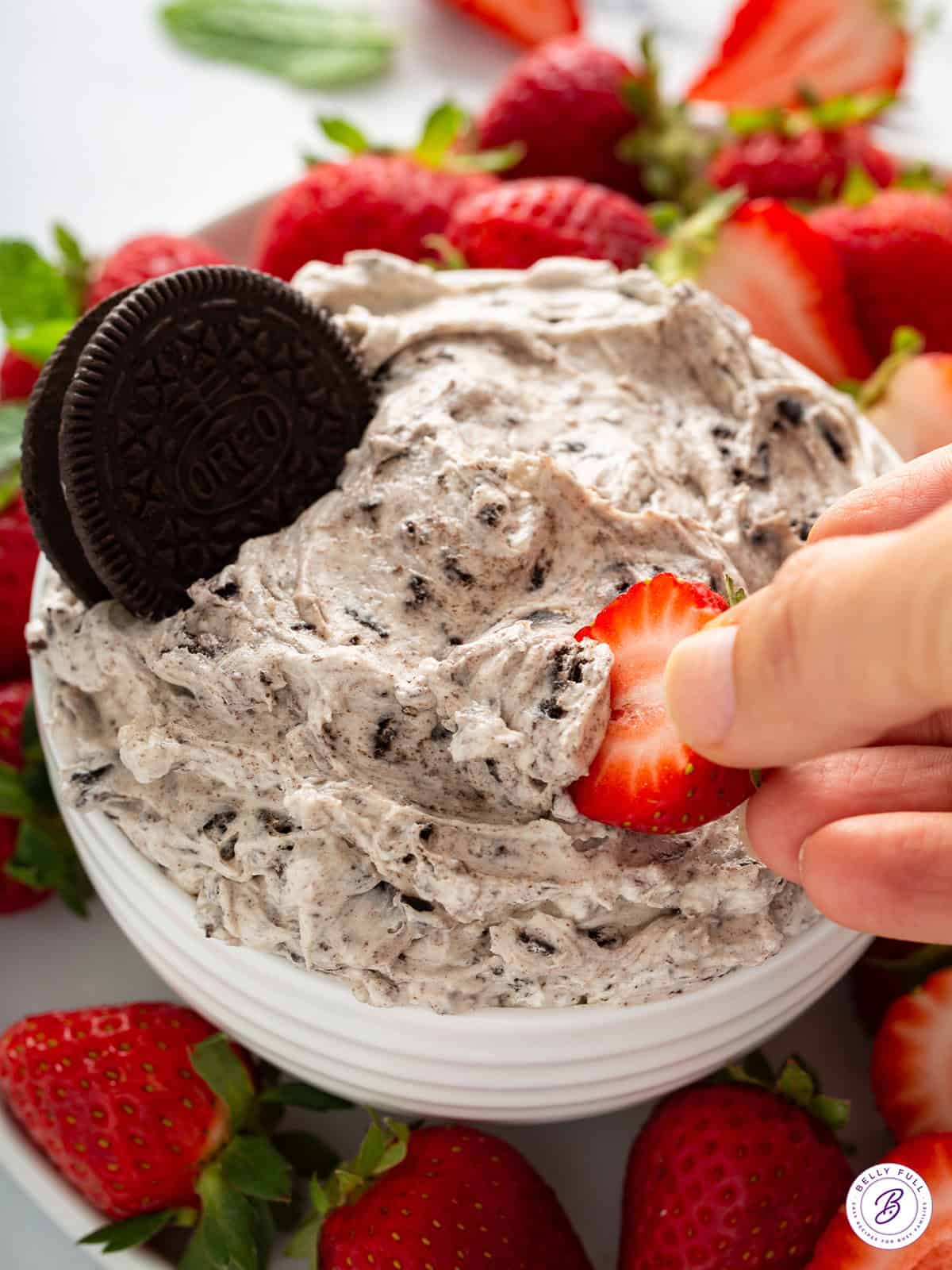 strawberry with mound of cookies and cream dip