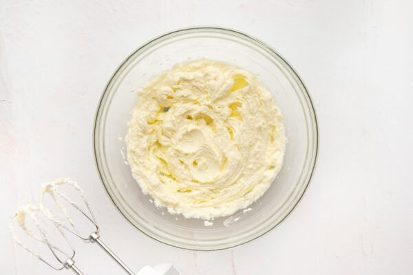 Creamed butter and sugar in a glass mixing bowl.