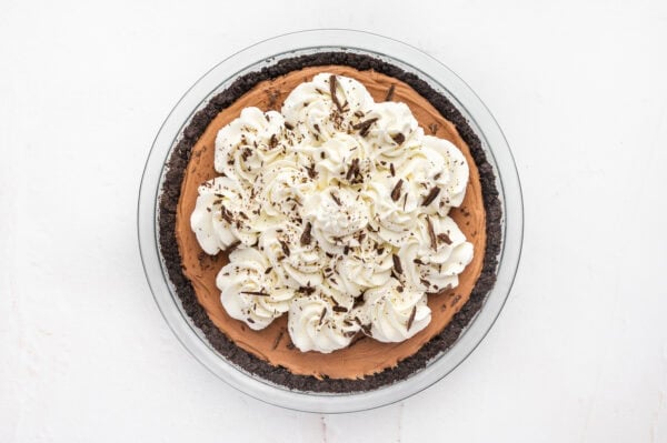 Finished french silk pie with whipped cream and shaved chocolate.