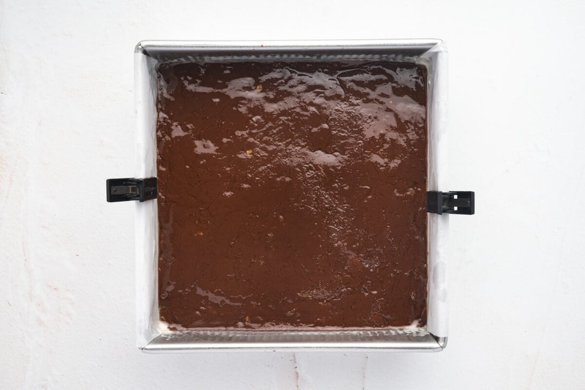 Fudge mixture smoothed out in a parchment lined baking dish.