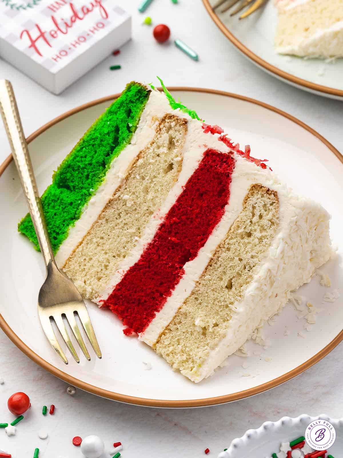 A slice of 4 layer Christmas cake on a plate