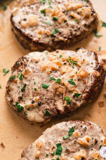 Overhead view of beef tenderloin with pepper cream sauce