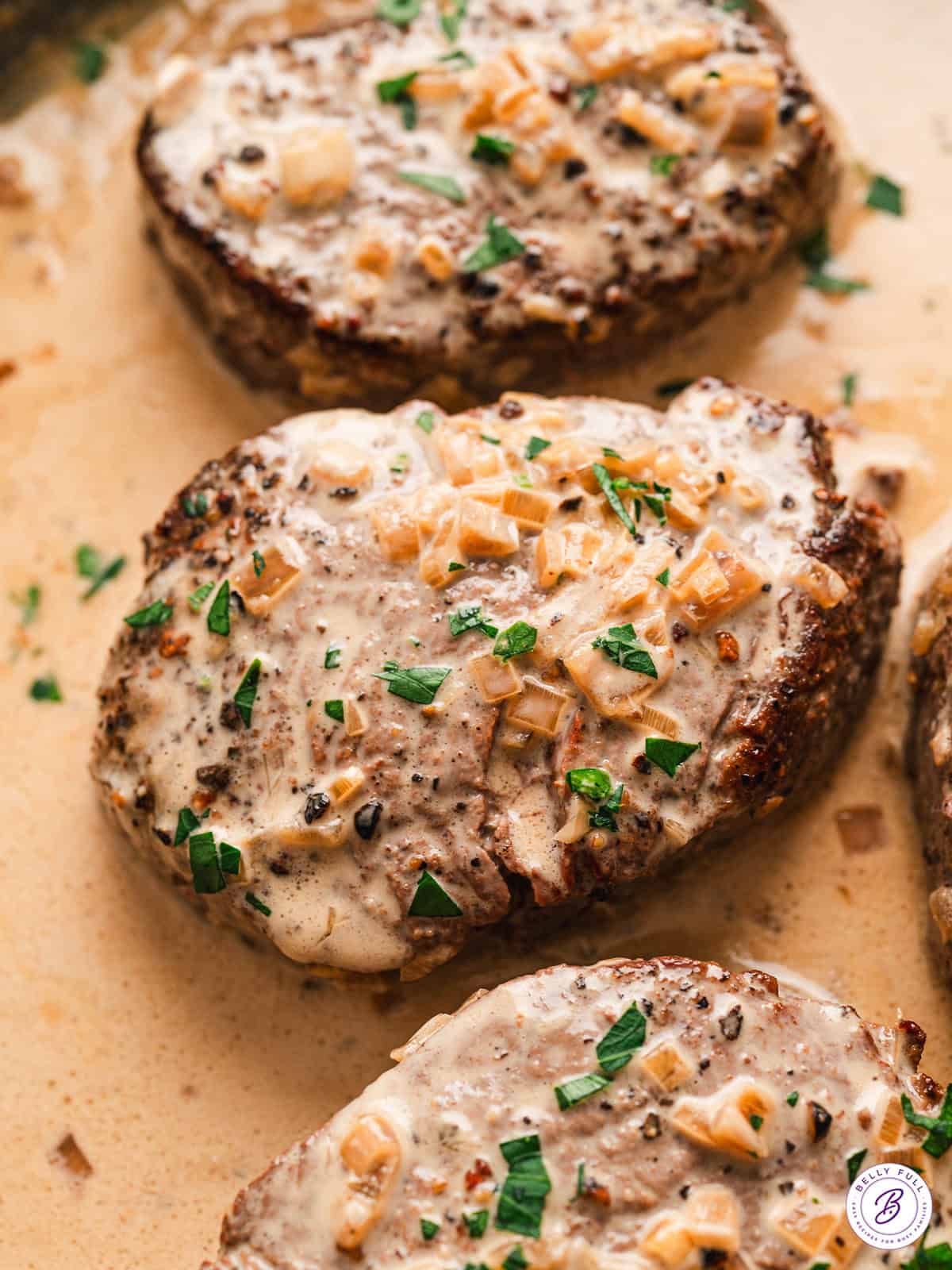 Overhead view of beef tenderloin with pepper cream sauce