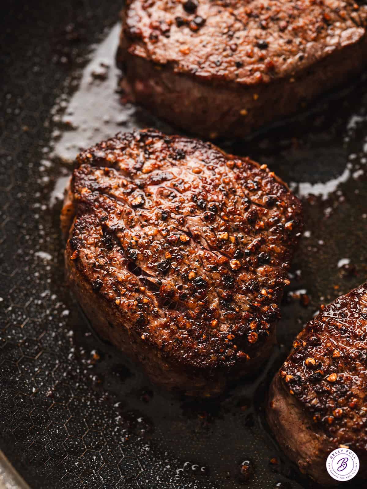 Close up of beef tenderloin steak in a cast iron skillet