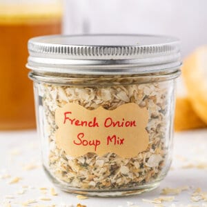 Side view of dry french onion soup mix in a glass mason jar.